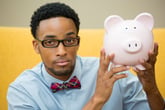 Smart man holding a piggy bank