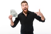 Happy man with beard excited about cash back or extra money