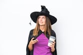 Woman in witch costume drinking coffee