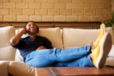 Man relaxing at home on his sofa