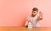 Man holding up his hand to stop a home purchase