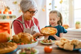 Grandmother and granddaughter look at fall pie