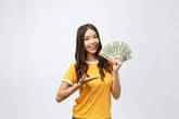 Happy woman holding cash