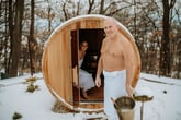 Happy smiling senior couple enjoying an outdoor sauna in winter