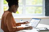 Woman using a calendar on a laptop
