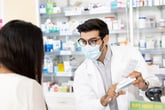 Pharmacist explaining a prescription medication to patient at pharmacy