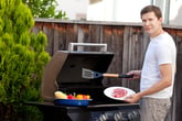 Man cooking steak on a grill