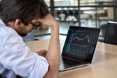 Man looking at stock charts and worrying about recession