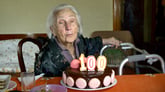 Centenarian with birthday cake
