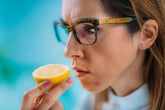 Woman sniffing a lemon