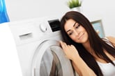 Woman next to clothes dryer