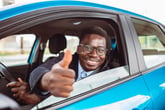 Happy driver gives thumbs up