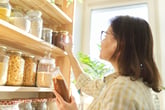 woman looking at pantry ingredients