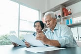 Senior couple studying finances or taxes or financial paperwork