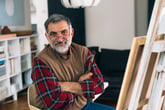 Retired man painting at an easel
