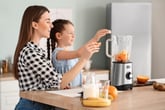 Mother and daughter using a blender