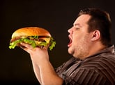 Man about to eat a giant hamburger
