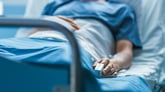 Man lying in hospital bed