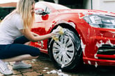 Woman washing car tires