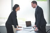 Businesswoman arguing with a businessman in an office or company setting