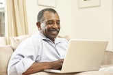 Happy retiree on a laptop