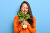 woman happy with green leafy vegetables