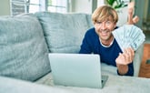 Man with lots of money on laptop