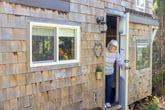 woman opening door to tiny house welcome in