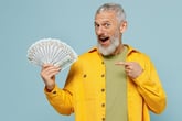 middle age man pointing to cash