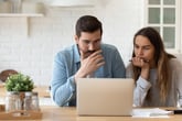 concerned couple looking at computer