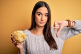 Unhappy woman eating chips