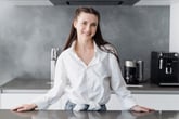 woman standing by kitchen counter