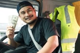 Happy truck driver smiling with money
