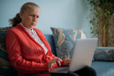 Older woman shopping online at a confusing website with tricky sales tactics
