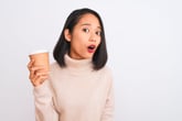 Worried woman holding a cup of coffee