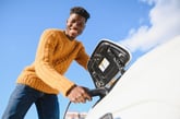 Man charging an electric vehicle