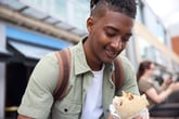 Young man eating a burrito
