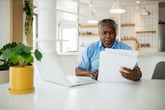 Worried senior man paying bills on laptop
