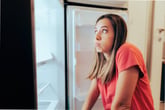 Woman with an empty fridge