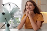 Woman sitting in front of a fan