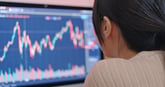 Woman watching the stock market on computer