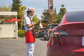 In-N-Out waiter or employee taking an order in the drive thru lane for fast food