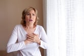 A woman having a heart attack or sudden cardiac arrest.