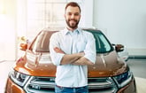 happy man standing in front of car