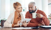 Couple looking at bills calculating Social Security