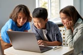 school kids using laptop computer together