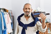 Happy senior man with wallet fully of money and credit card ready for travel or vacation