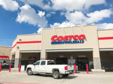 Exterior of a Costco warehouse store with a pickup truck in front