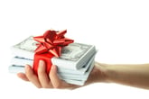 Money gift in a female hand