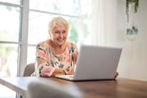 Elderly woman working on her laptop